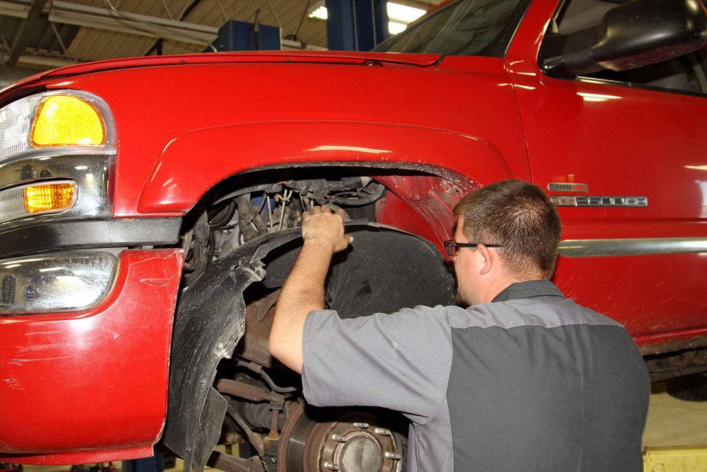 removing the plastic fender liner from each side, being careful not to damage the plastic retaining clips.