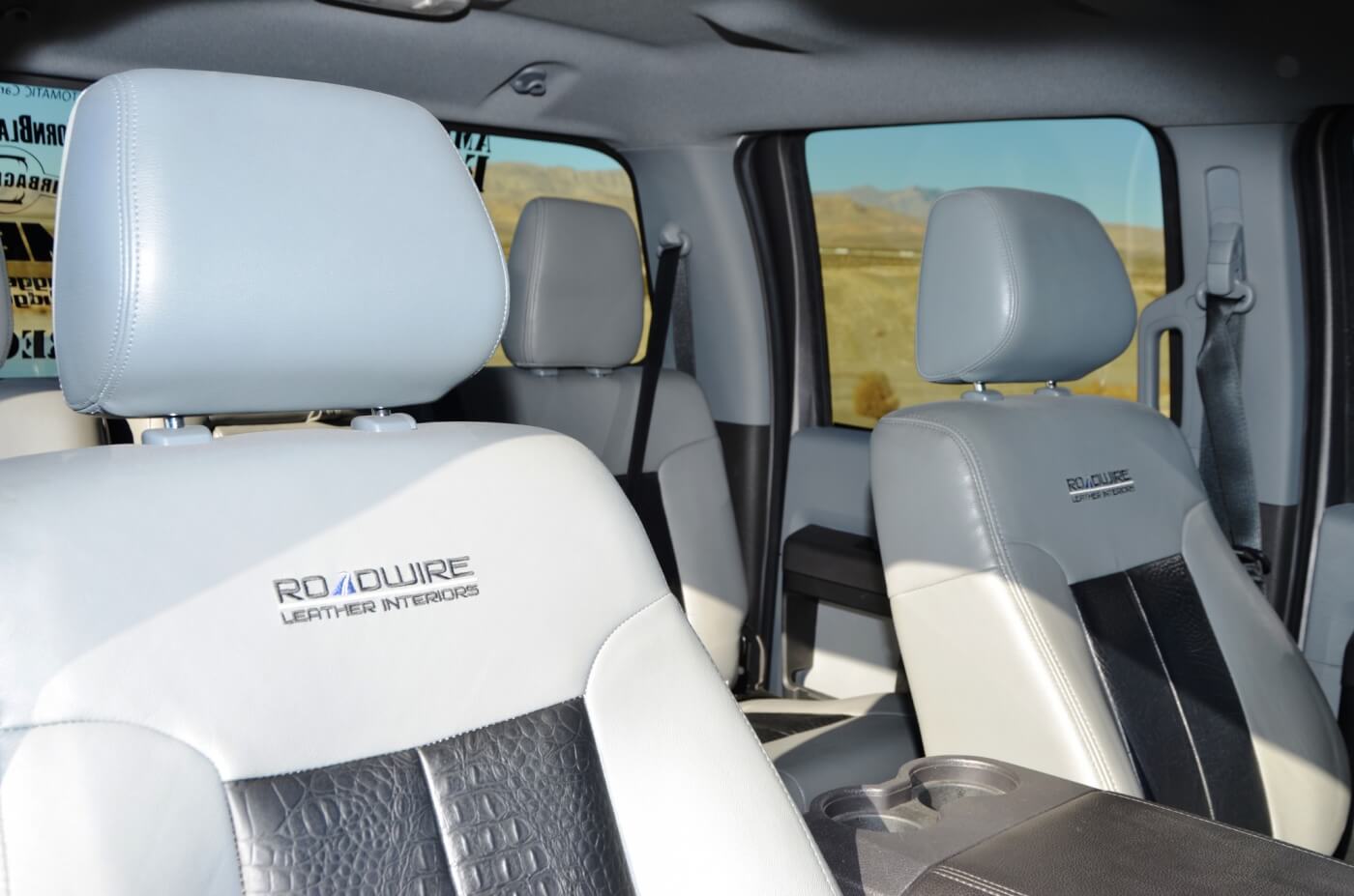 The interior features a mass of stereo upgrades from Pioneer and PowerBass as well as multiple monitors for passenger TV viewing. The seats were wrapped in custom two-tone leather for the utmost in road trip comfort.