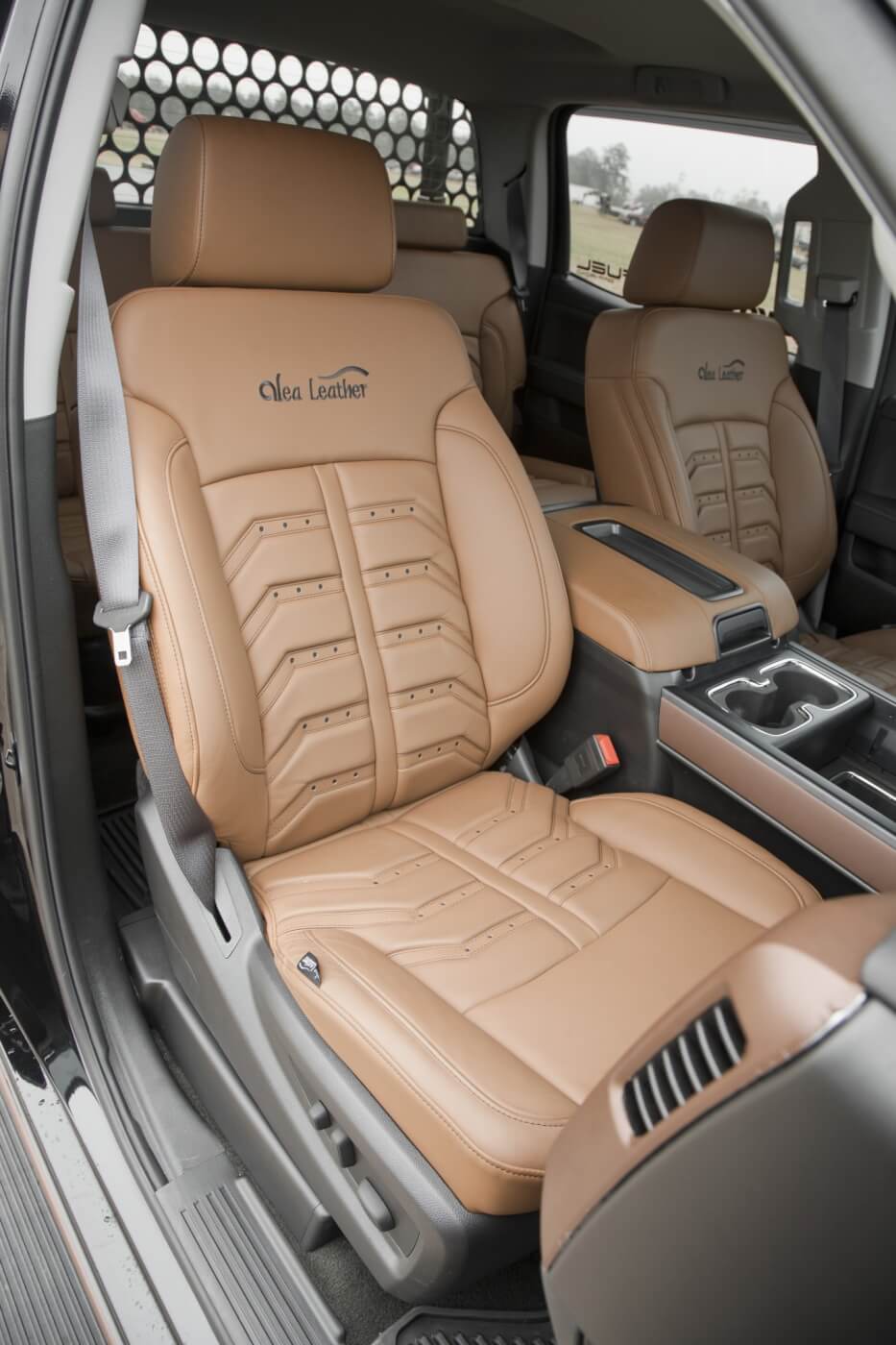 The interior is mostly stock, with the stock seats being recovered with Amaretto-colored Napa grain leather covers from Alea Leather. The sound system was also upgraded with Kicker speakers tied into the factory touchscreen head unit.