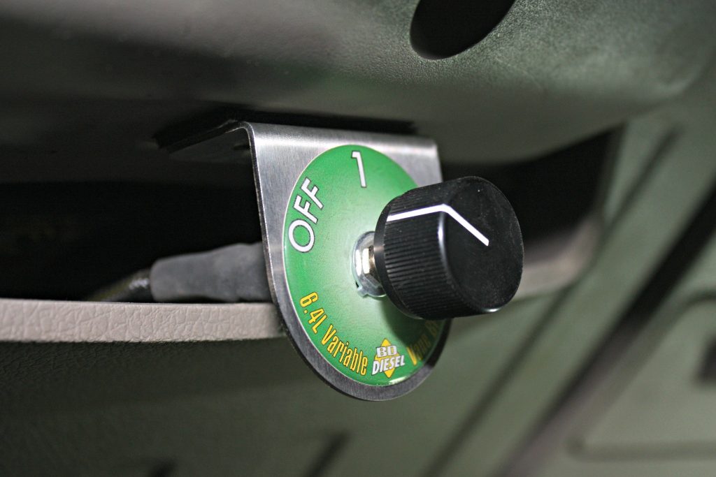 11. The VVT system is controlled in-cab with a three-position switch that can be mounted just about anywhere the owner prefers. The small bracket offers endless mounting possibilities, but directly under the steering column offered the easiest reach without being in the way or requiring any drilling. Running the switch in “off” allows the turbos to work like stock. Position One is Vane Control only for mild engine brake, while Position Two offers a Vane Control along with a more aggressive transmission downshift pattern to maximize engine braking.