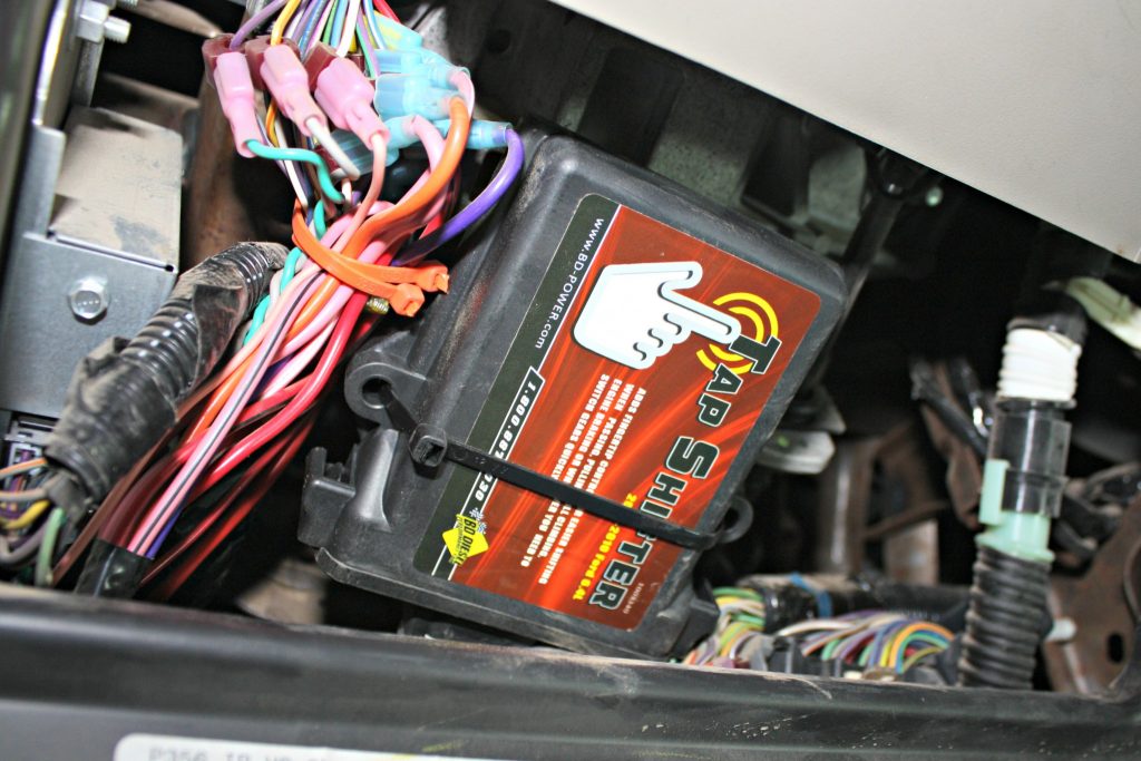 3. The Tap Shifter control box mounts under the dash and includes a professional-grade wiring harness to make the installation virtually plug and play. The kit will piggyback the factory OBD-II port and shift selector pigtail. There's one wire down along the frame that will need to be spliced and tapped into the BD module.