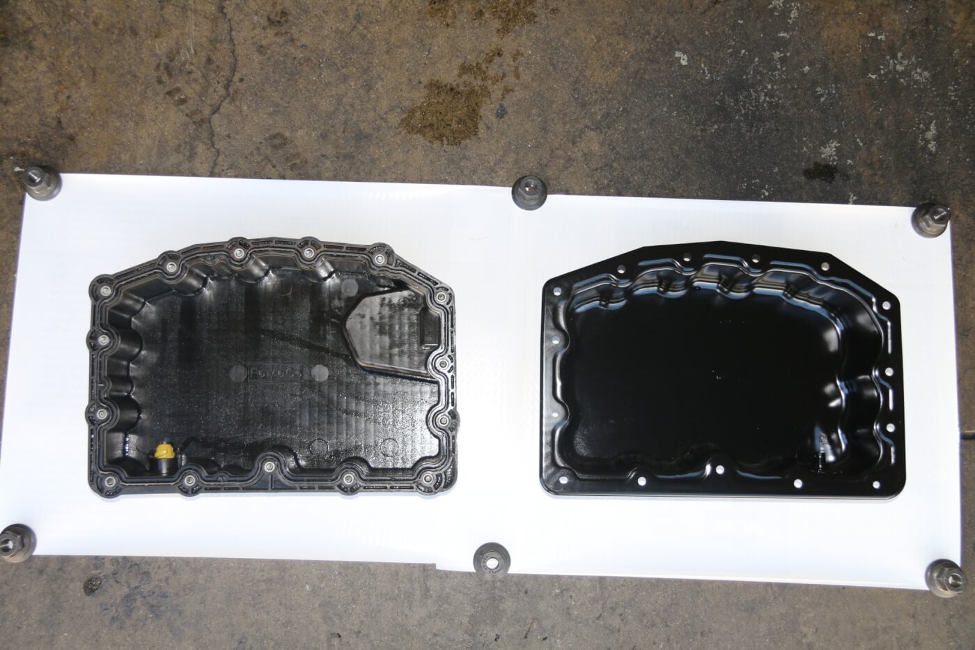 5. This view shows the inside of the composite pan (left) and the new stamped steel pan (right). Notice that the composite pan has an integrated gasket, making it a one-time use item. 