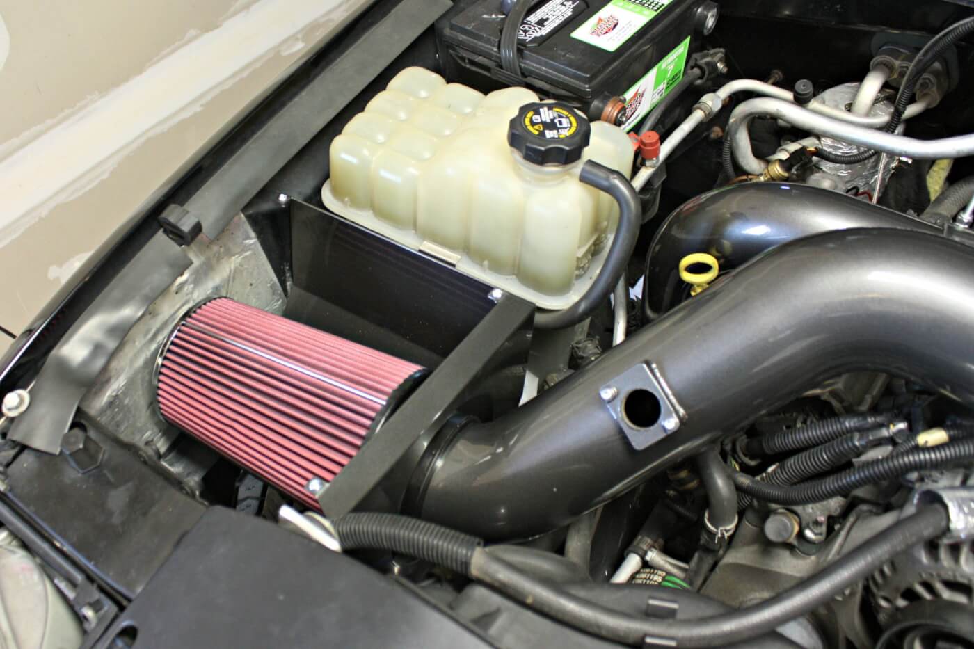 10. The final piece of the puzzle is the hand-fabricated airbox and 4-inch, mandrel-bent intake pipe that routes clean, filtered air into the mouth of the new turbocharger. The complete system comes powdercoated in your choice of color, so it not only improves performance, but looks incredible doing it.