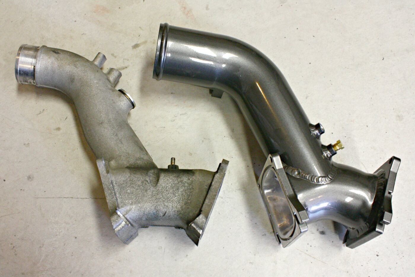 4. The factory Y-bridge uses a 2.5-inch inlet to feed air into both cylinder heads. The cast aluminum piece is also outfitted with an air intake heater that blocks the passageway inside the already small-diameter bridge. To increase overall airflow for larger aftermarket turbo and reduce restriction within the system, HSP Diesel hand fabricates a larger, 3-inch Y-bridge that eliminates the air-intake heater and offers smoother transitions to eliminate air turbulence before the cylinders.