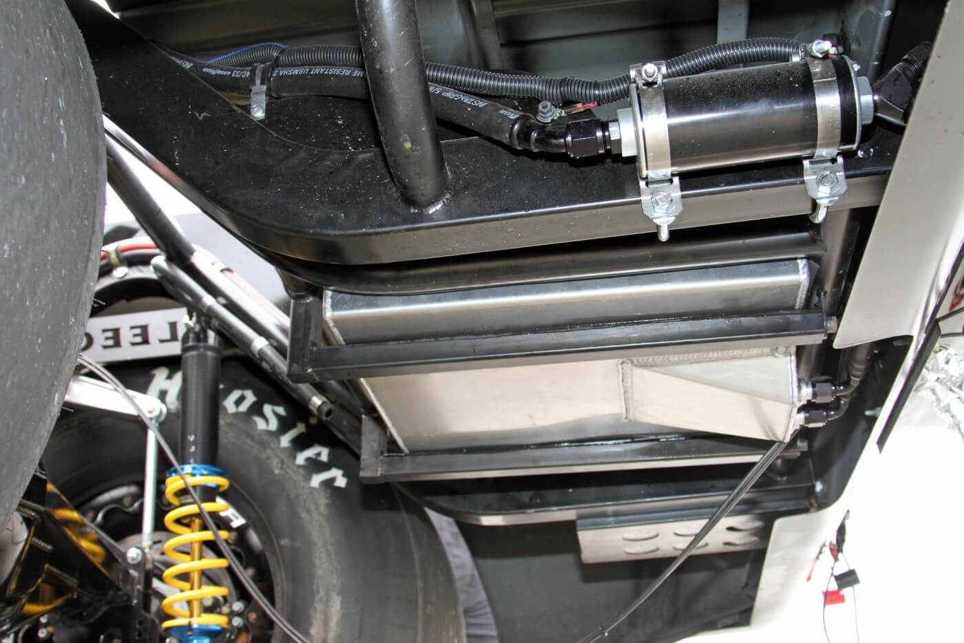 Crawling under the rear of the truck, you’ll see the aluminum fuel cell securely mounted between the new frame rails. You can also see the Fuelab electric pump on the outside of the driver side rail and the battery mount on the outside of the passenger side rail.