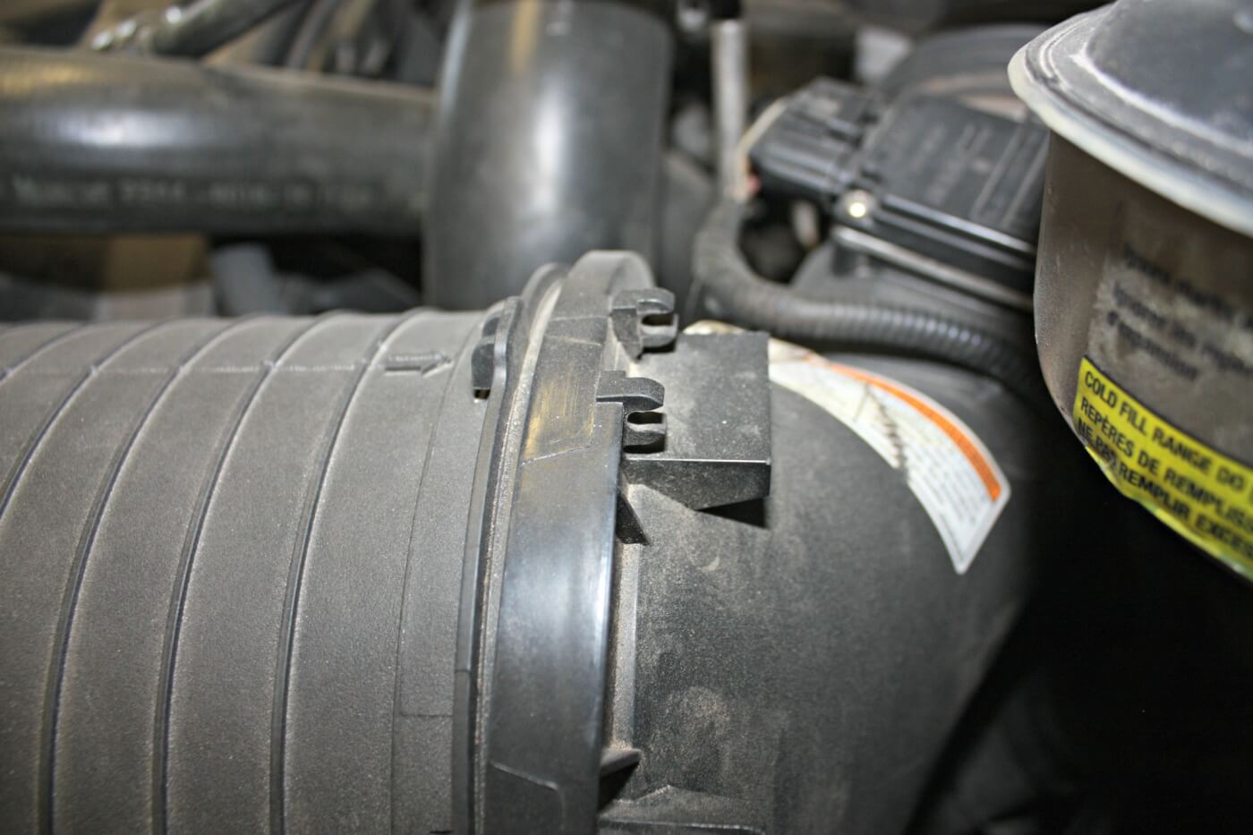 2. The factory air box uses a large oval-shaped paper filter that does its job well; however, its design makes servicing a bit of a hassle, and replacement filters can be quite expensive. It’s also common for the metal clips that help seal the box to break or come up missing, allowing unfiltered air to enter the turbo.