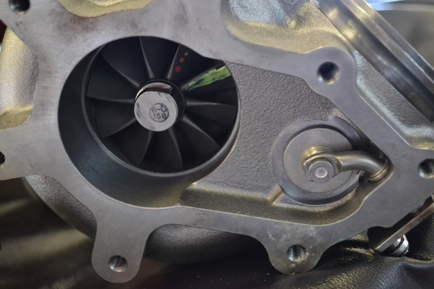 If you notice a funny-looking flange coming off the exhaust of some turbos, it’s because they have internal wastegates. An internal wastegate (arrow) is used to bypass the turbine wheel if drive pressures get too high.