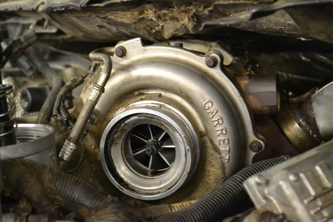 Turbos can lead a hard life, as evidenced by this grime-covered unit tucked under the firewall. Still, due to their simplicity, outright failures aren't very common in most engines.
