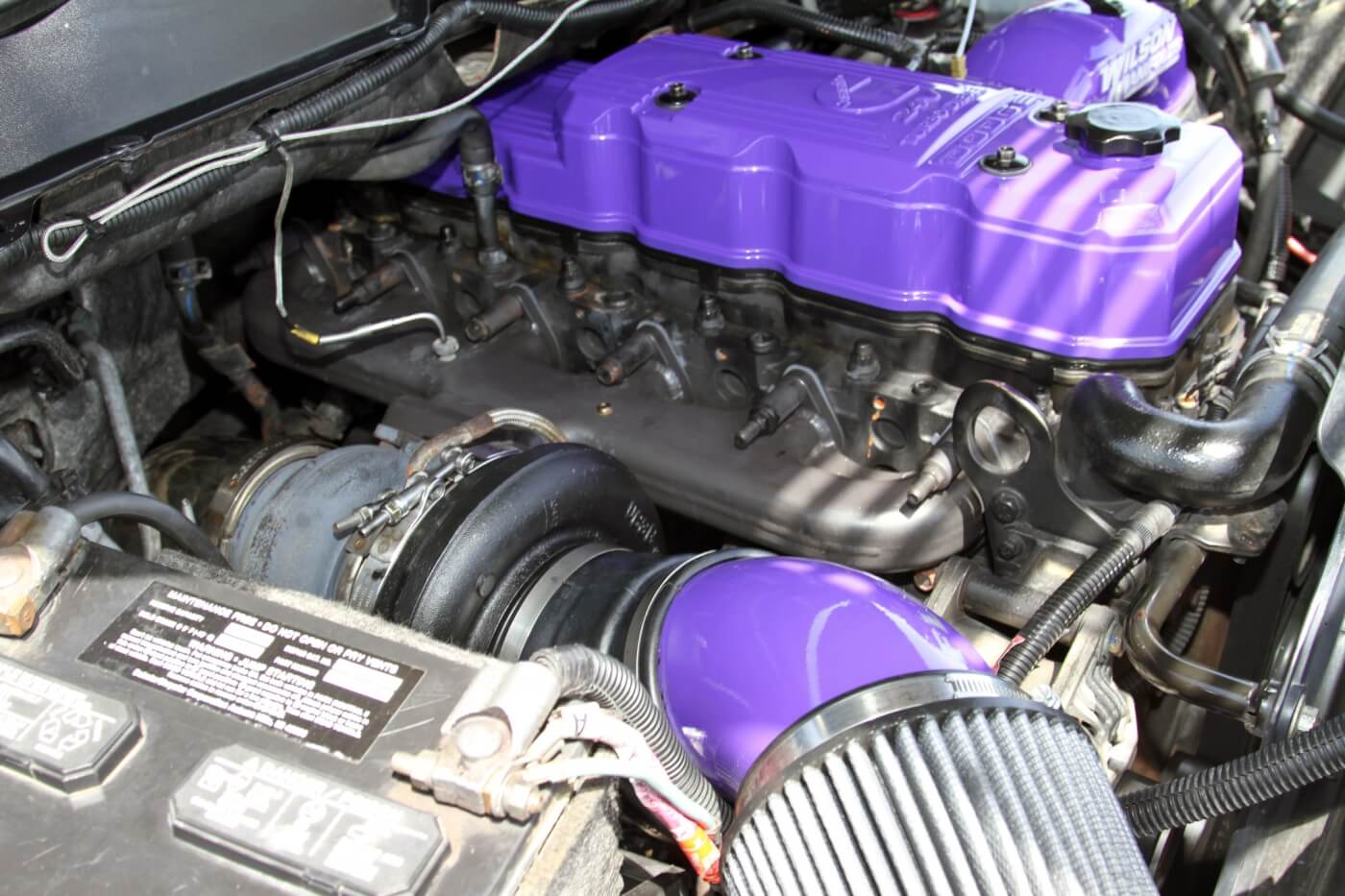 The passenger side of the 5.9L Cummins is dominated by a Steed Speed manifold and a Fleece Performance Engineering S468 turbocharger.