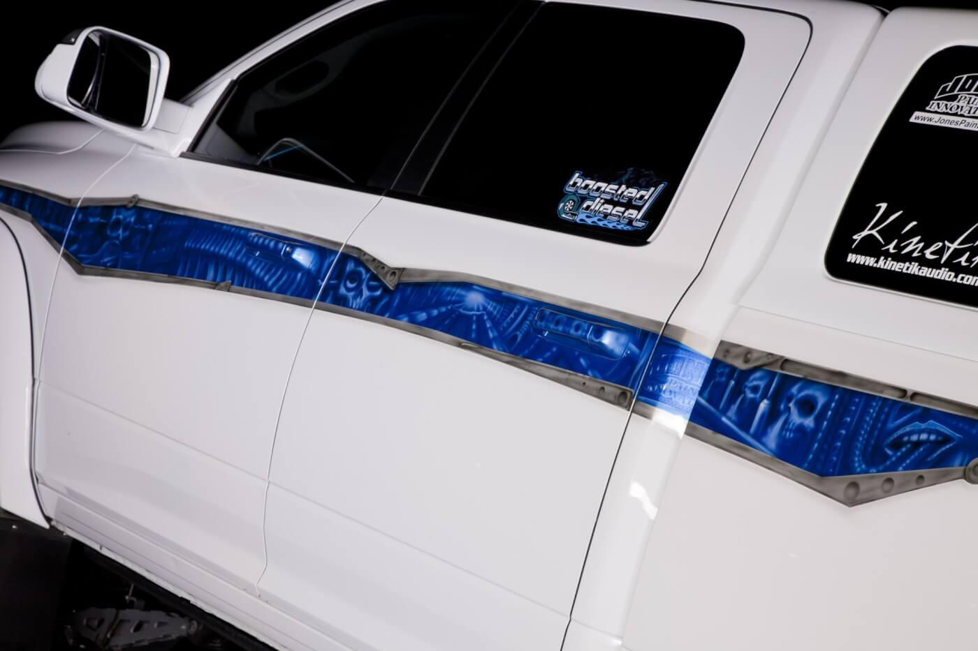 Josh Jones at Jones Paint Innovations (JPI Hot Rods) dropped some style on the Ram’s exterior with a beltline graphic filled in with Dodge SRT Blue and airbrushed with all sorts of eye-snagging details and pin striping. 