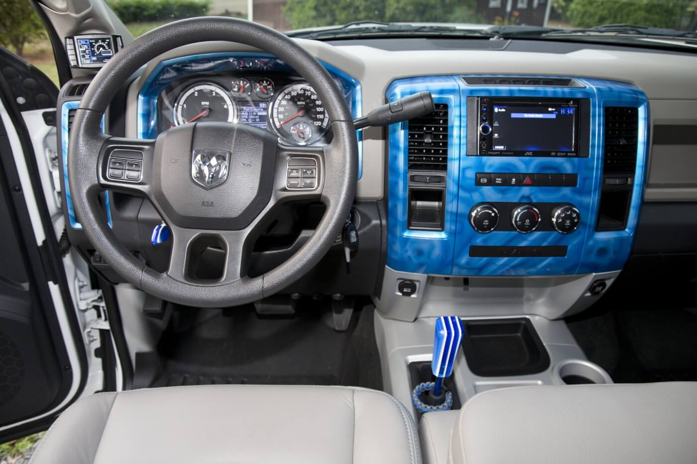 The interior of his truck, BIO Ram, is spiced up with blue accent pieces and fabric styled by Katzkin.