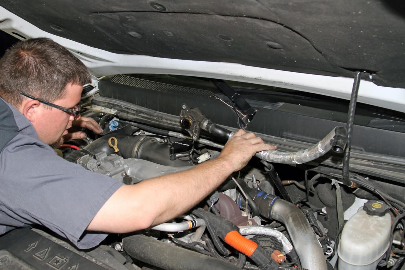 13. Once both bolts are removed, the PCV hose assembly can be lifted out of the engine bay.