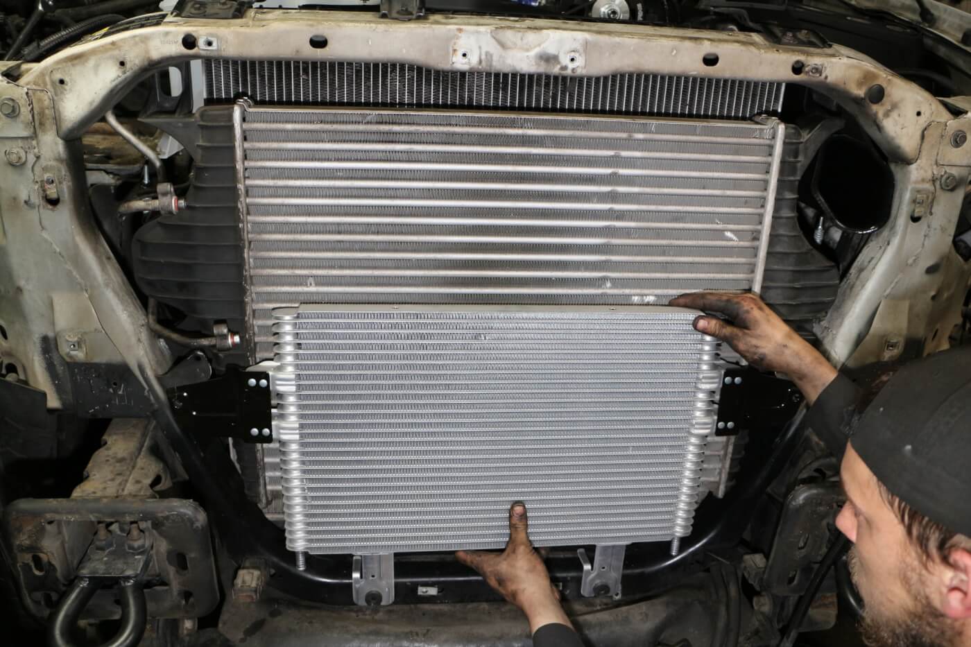 14. If your truck has had the automatic transmission fail catastrophically, a new oil cooler is recommended. This and flushing the hard lines will keep metal shavings from the old system from contaminating your new setup. Here you see a larger transmission oil cooler from a 6.0L Ford being installed. (The June 2015 issue of Diesel World has more on this upgrade.)