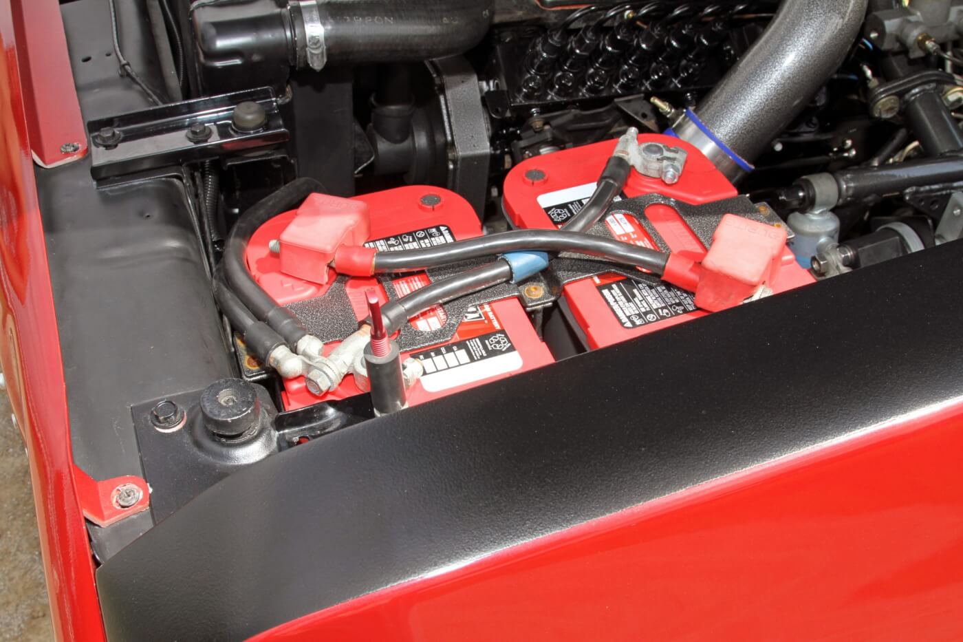 Reese mounted a pair of Red-Top Optima batteries on the driver side of the engine bay to turn the big Cummins over with no problems.