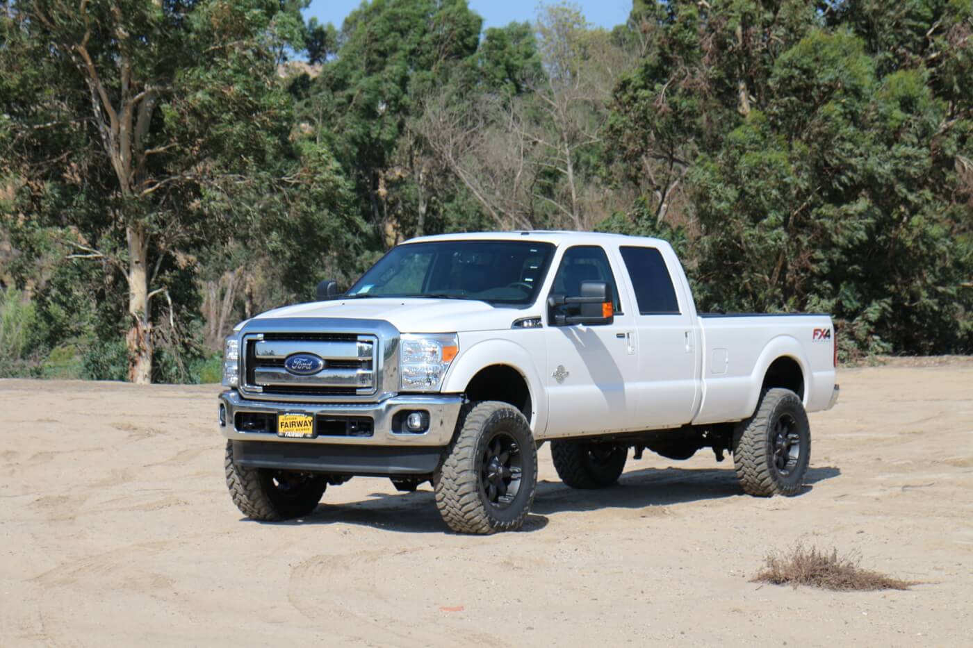 Seen here is a stock F-250 (top). Here's the same truck with a Carli Suspension Dominator 3.0 kit (bottom).