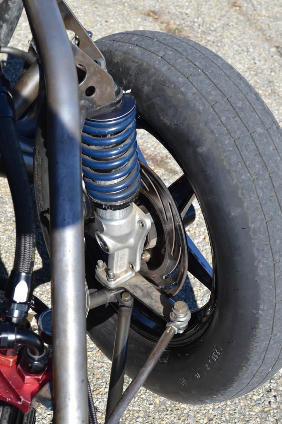 The front suspension is also a drag race affair, as Strange struts are employed. Combined with a rack and pinion steering unit, the entire front steering, suspension, and brakes are well under 100 lbs. combined.