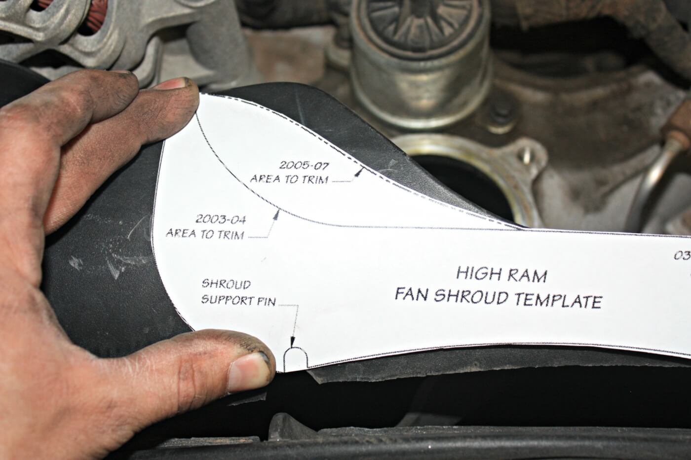 13. To make room for the larger High Ram intake elbow, the upper fan shroud plastic is going to need some minor trimming. The included template makes it easy to mark where the cuts need to be made. Just a small notch needed removed on this 2005 model. The 2003-2004 trucks will need trimmed a bit further.