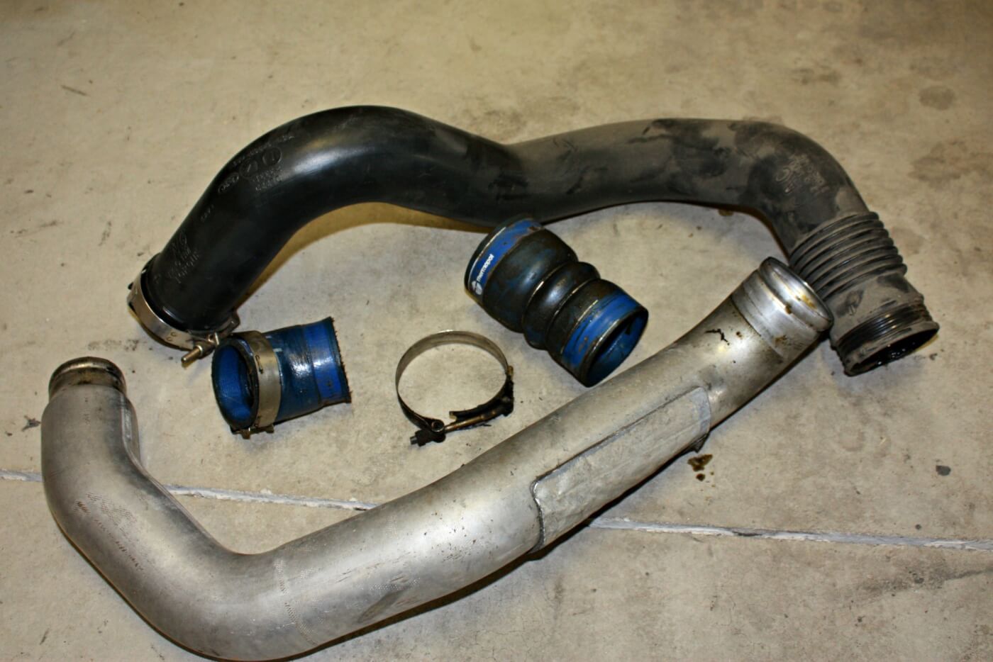8. Note the stock intercooler pipes while serving their purpose of getting charged air from the turbocharger outlet to the engines intake manifold. The poorly designed and crimped piping definitely won’t flow like the Banks system does. The factory oil saturated intercooler boots will also be replaced.
