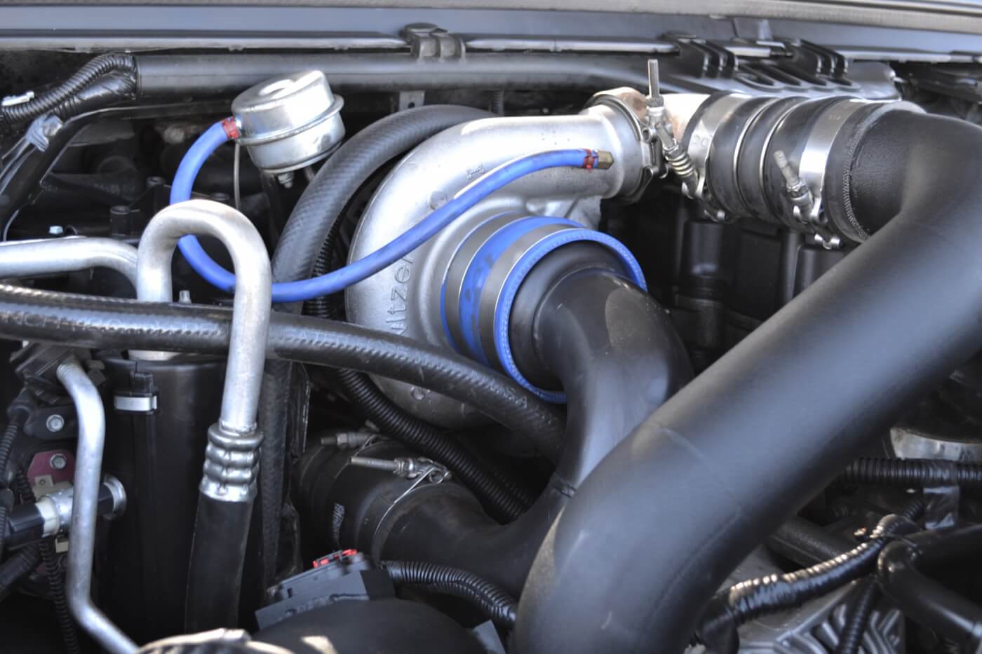 After the air is initially compressed by the big turbo, it is then fed through a 64mm turbocharger built by Engineered Diesel, which sends a whopping 70psi of boost through a Banks Power Stroke intercooler and into the engine.