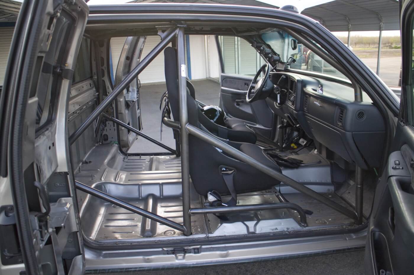 To lighten the truck, the interior was stripped out. A cage from Rollover Motorsports was installed for safety. The stock seats were replaced with a pair of Corbeau seats with 5-point belts.