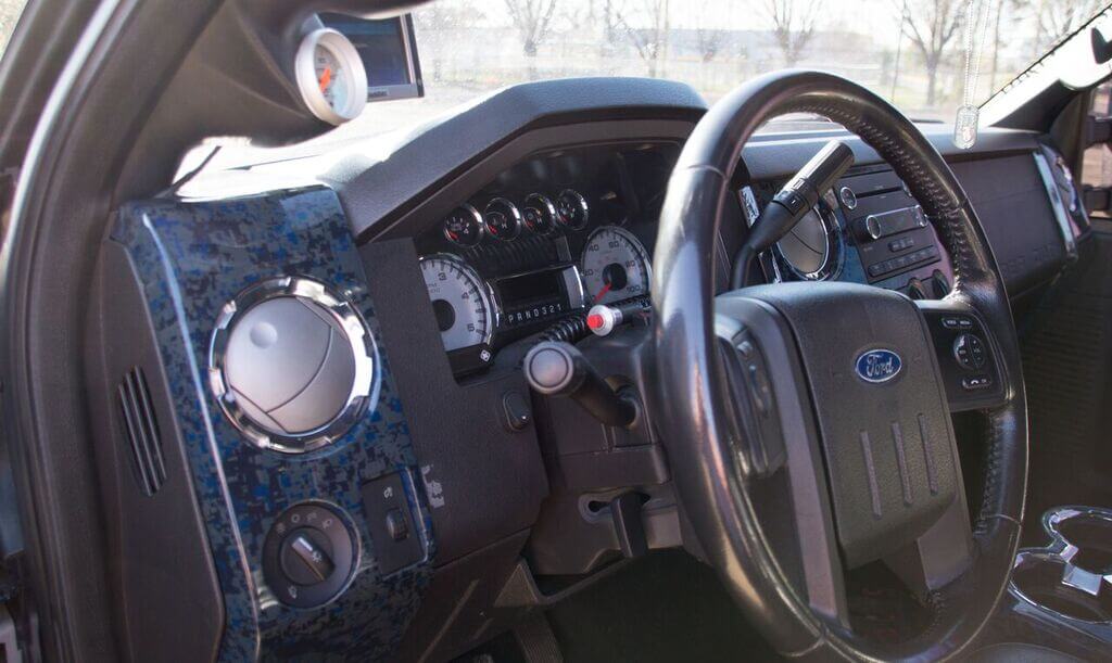 The interior of the truck has been kept pretty simple; beside the hydro-dipped digi-camo panels from Baltimore Hydrographics, you'll find a DashDaq monitor for watching engine vitals, a couple 0-100psi gauges to watch boost and drive pressures, and a handheld nitrous switch for when the need arises.