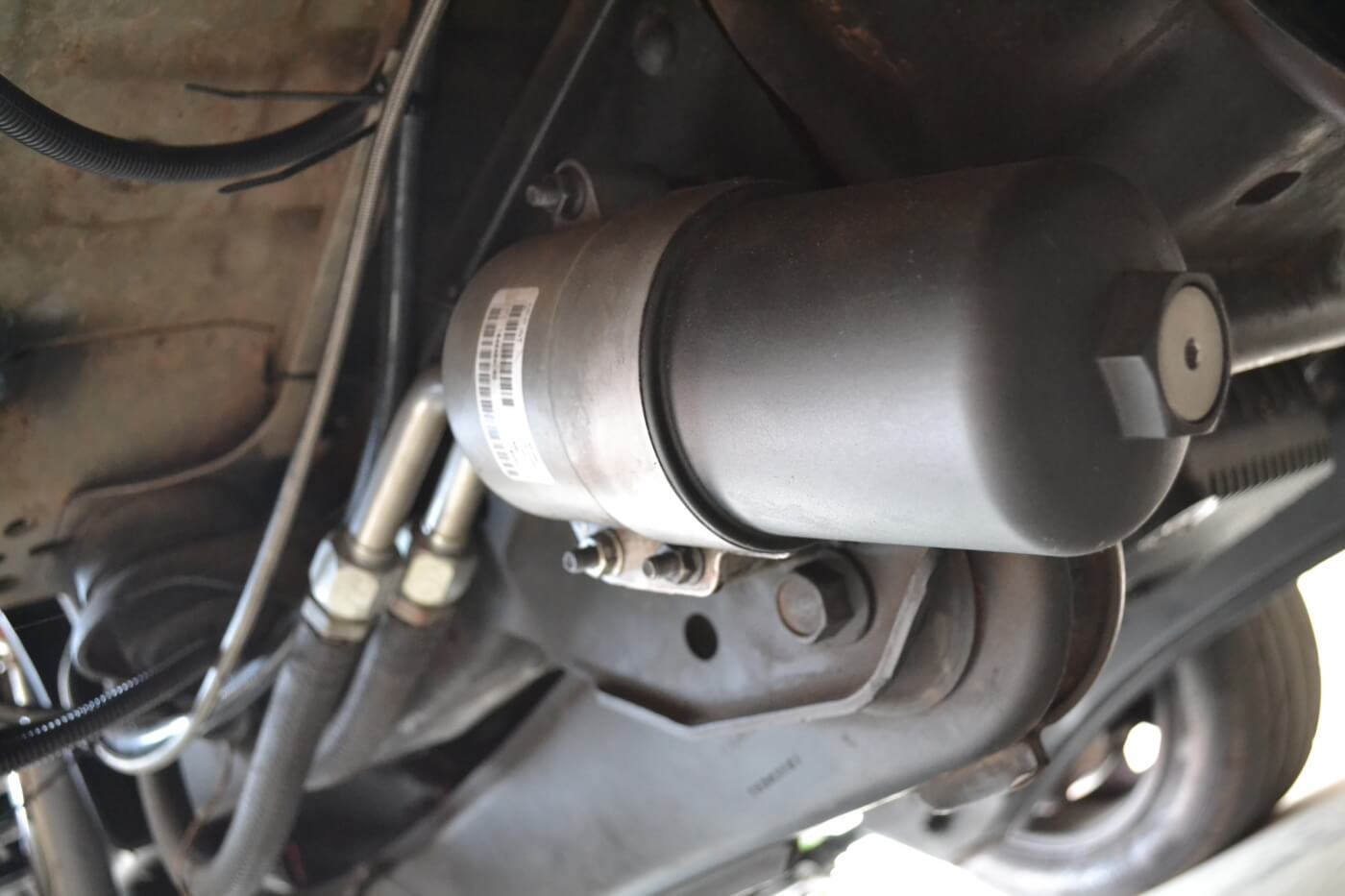 With a bunch of turbos, piping, and other hardware taking up under-hood space, the factory oil filter was relocated to the frame rail of the truck. This was done with factory Ford parts, as an E-series Ford van actually uses this type of setup.