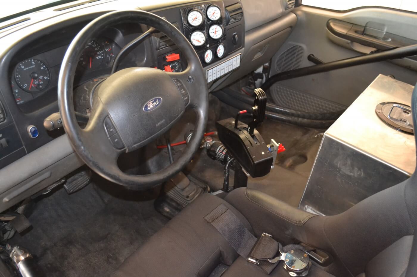 Much of the factory interior on Matt's truck has been removed and replaced with a racing seat, pushbutton switches, and the big intercooler tank. If Matt decides to drop even more weight, the power windows and factory dash are the next to go.