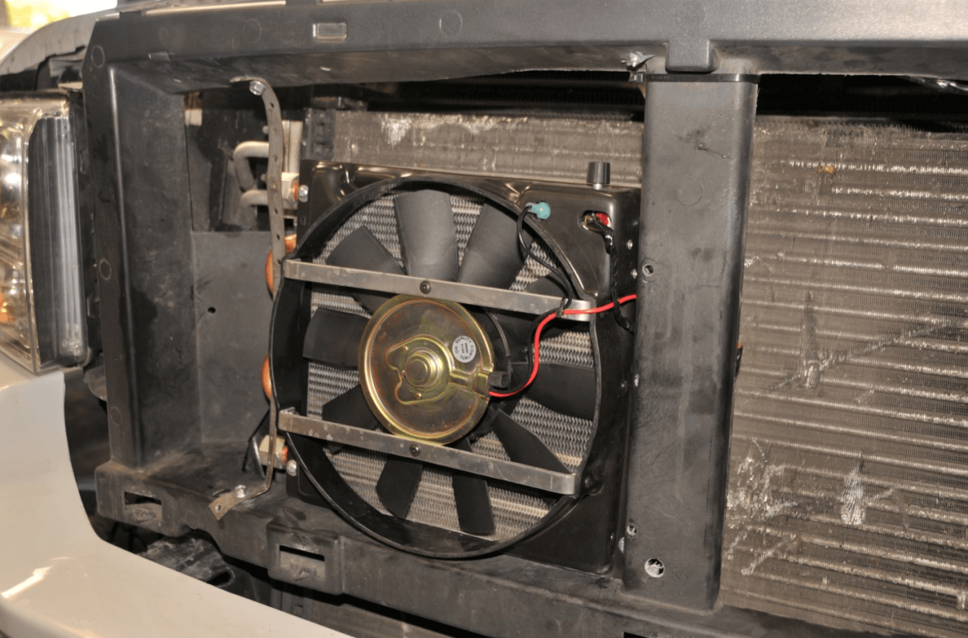 15. Next came the Flex-a-Lite Transmission Cooler. After removing the factory grille to gain access the cooler/fan combo was mounted right in front of the radiator with some straps. The cooler can be mounted anywhere and the fan can run in either direction.