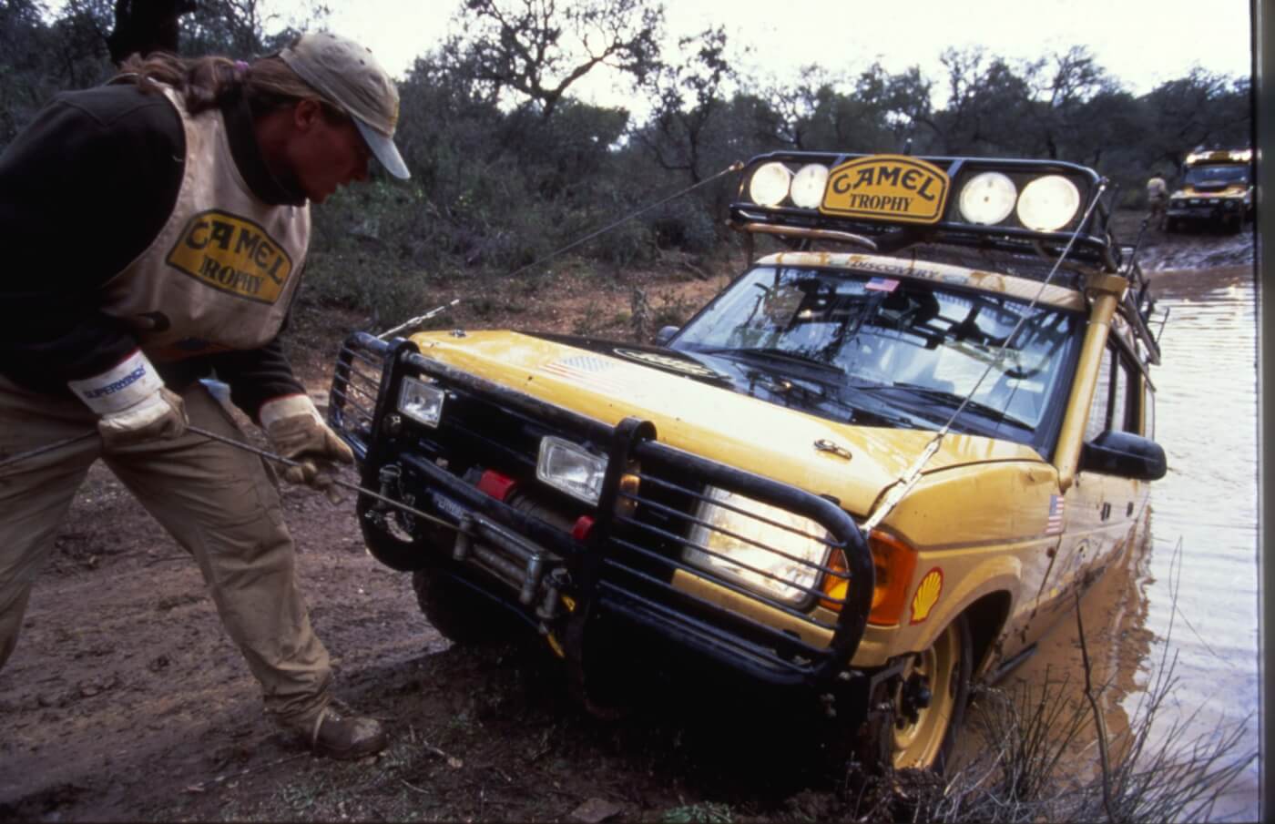A good many times, the Discoveries operated in wet environments. With their heavy loads, open diffs, and completely inhospitable terrain, winching and towing were commonly used skills. Here Ken Cameron from the 1996 event in Indonesia is shown training in Colorado in 1995 with the USA Team’s Discovery from 1992. This rig was actually lost in a river during training and was completely submerged. It had to be recovered with a diver’s assistance.