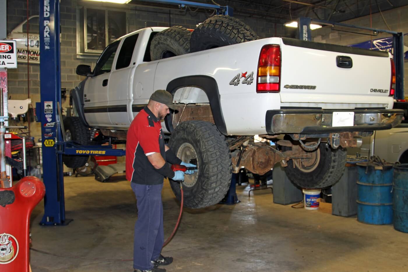 1. To start the Ultimate Rear Axle Build Jason Nelson puts the big Duramax truck on one of the twin post lifts in the RPM Offroad service bay and then removes the rear wheels.