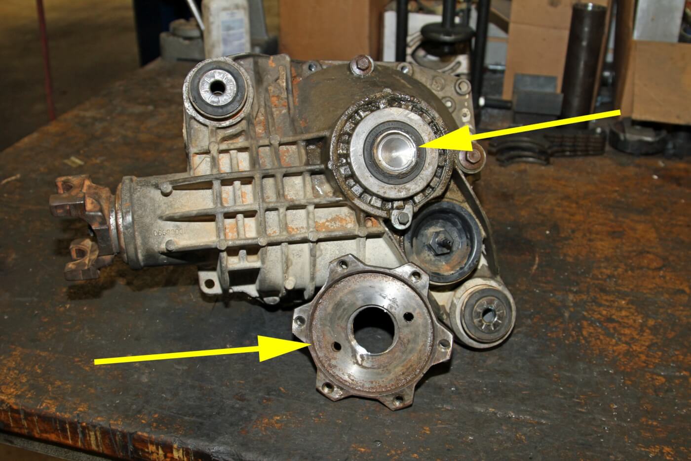 9. We had to have the crew at Twin City Auto Machine mill the flange off the axle shaft (see arrows) so that the case could be split with the axle shaft stuck in the differential.