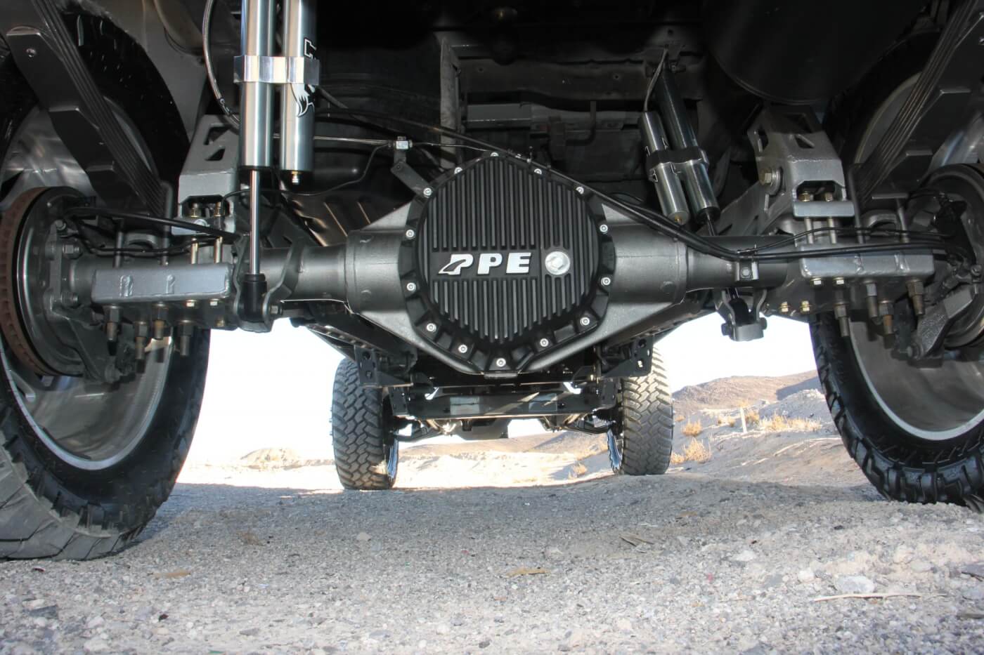 A high-capacity aluminum rear differential cover from PPE has been swapped for the stock cover. This aftermarket beauty adds oil capacity and aids in shedding heat. You can also see the remote-reservoir Fox 2.0 rear shocks and the Rize suspension mountings too. 