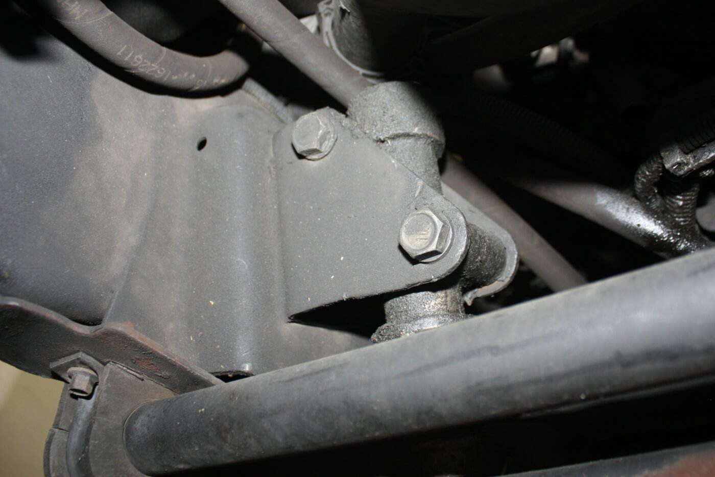 10. The idler arm is located on the inside of the passenger frame rail, attached to a small bracket with two large bolts. The idler arm creates a pivot point for the center link that attaches the steering box to the tie rod ends. Lifting the truck and adding large, heavy tires puts tremendous stress on the idler arm, and the stock piece is prone to failure under such circumstances.