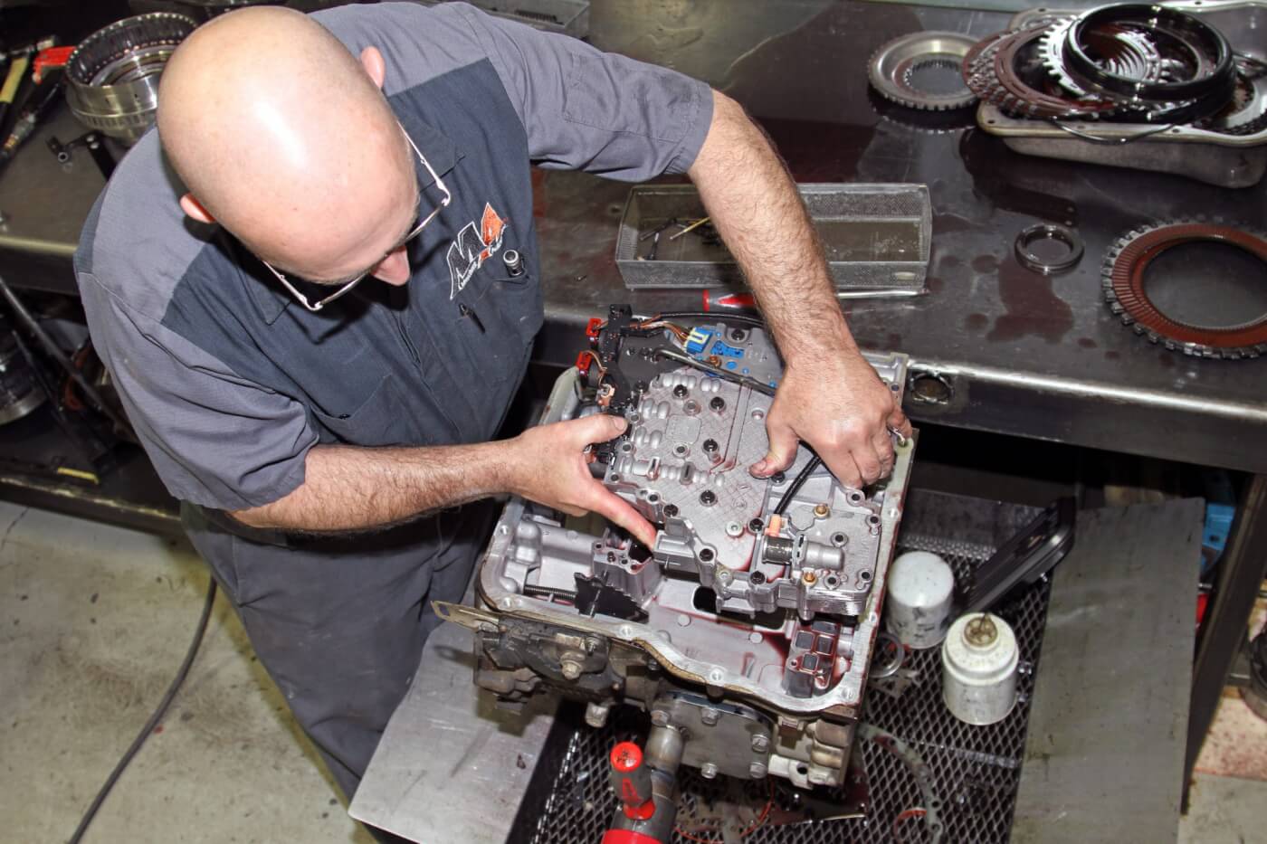 7. After rotating the transmission once again, Delo removes the valve body to give it a rebuild with the TransGo components to improve shift performance and control.