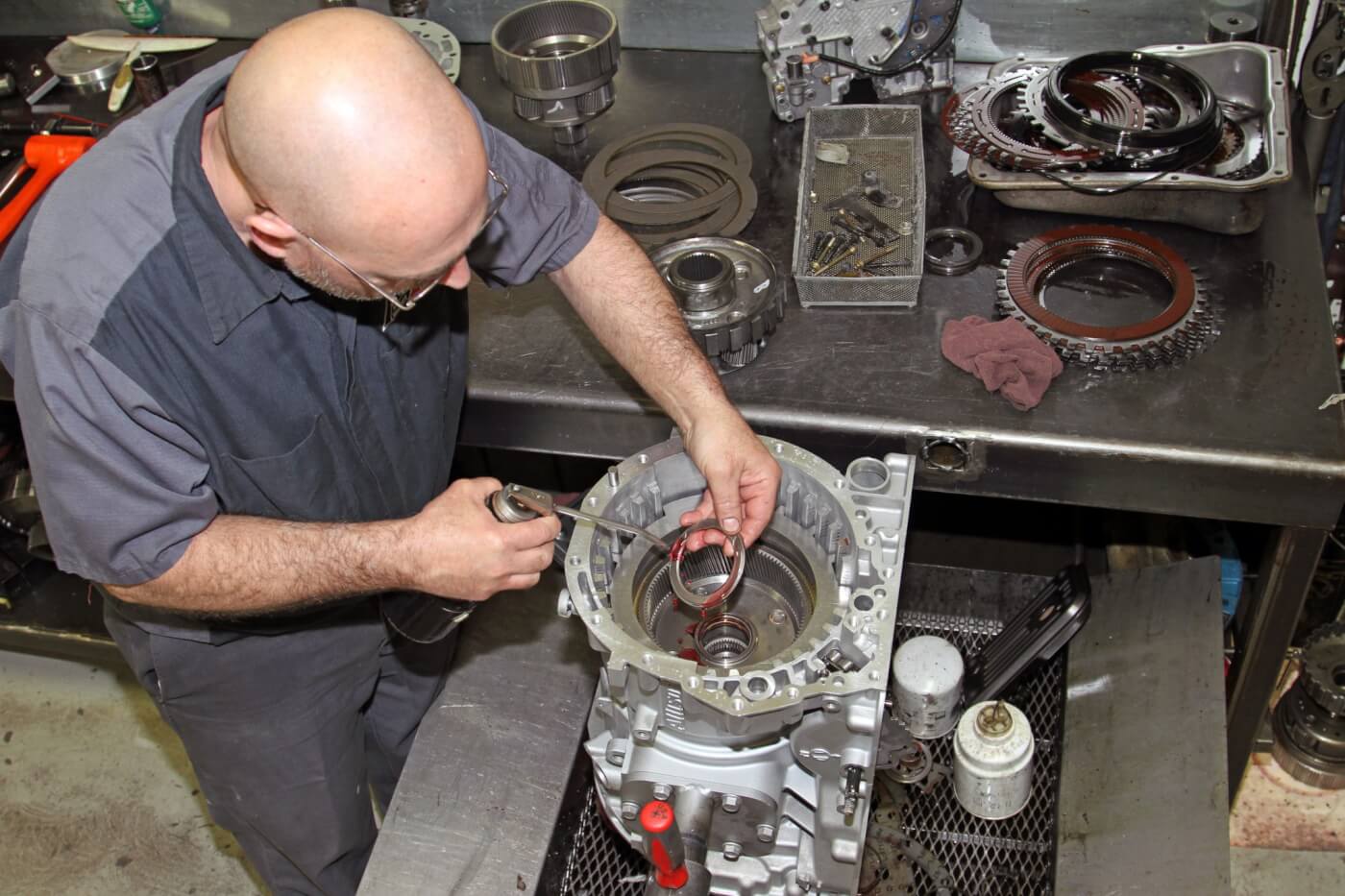 He carefully installs and aligns the new clutches and steels as well as the apply pistons and planetary gear sets lubricating the new Torrington bearings along the way.