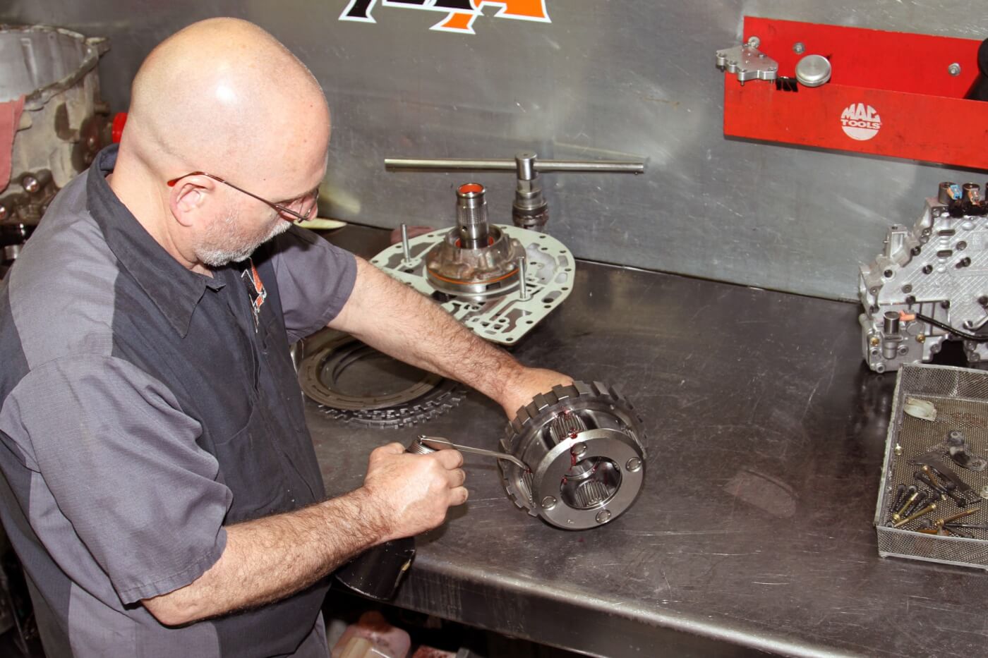 22, 23, 24. He carefully installs and aligns the new clutches and steels as well as the apply pistons and planetary gear sets lubricating the new Torrington bearings along the way.