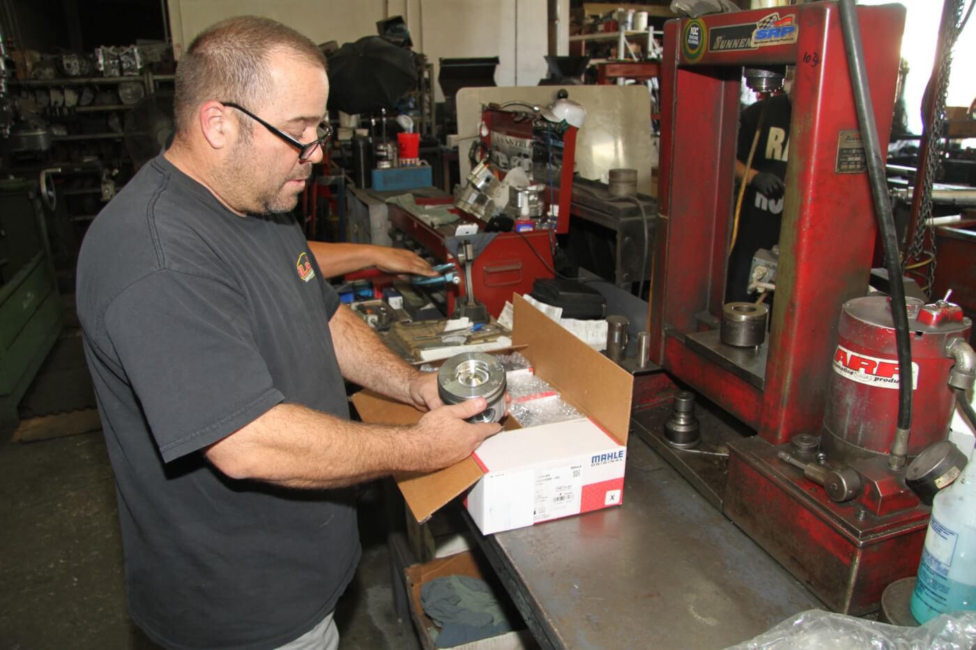 11. Derek Ranney, manager and co-owner of L&R Automotive, inspects the new MAHLE pistons before they’re installed in our 7.3L diesel. L&R has been in business for 38 years and supplies engine parts as well as top quality machine work for all types of engines. 
