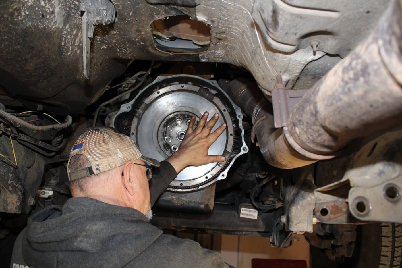 8. As mentioned earlier, this truck had already been upgraded with an aftermarket flywheel and clutch to replace the troublesome dual-mass system that the factory uses. Still, the Centerforce kit incorporates a new flywheel that must be used with the Diesel Twin assembly, so Hughes removed the old one. Keep a hand on the flywheel during flywheel removal, as it’s heavy enough to do some serious damage to feet and/or concrete if it falls off!