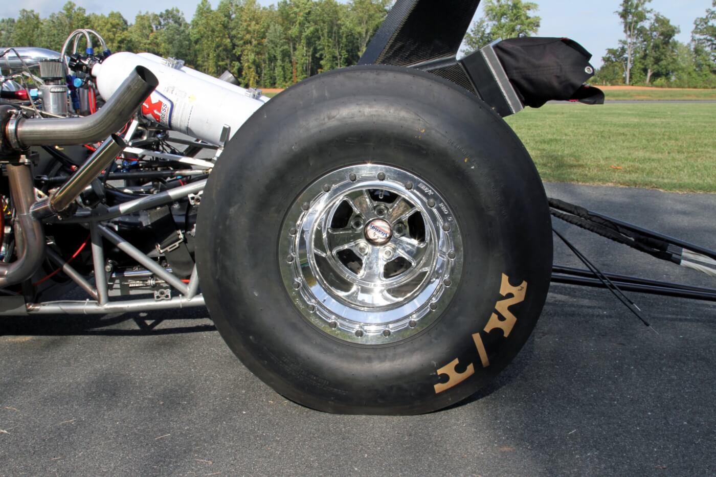 Massive 35.0/15.0-16 Mickey Thompson ET Drag slicks are securely held in place on the double beadlock Mickey Thompson Pro 5 wheels. You can also see the ends of the Strange Engineering axle shafts that deliver the power to the wheels.