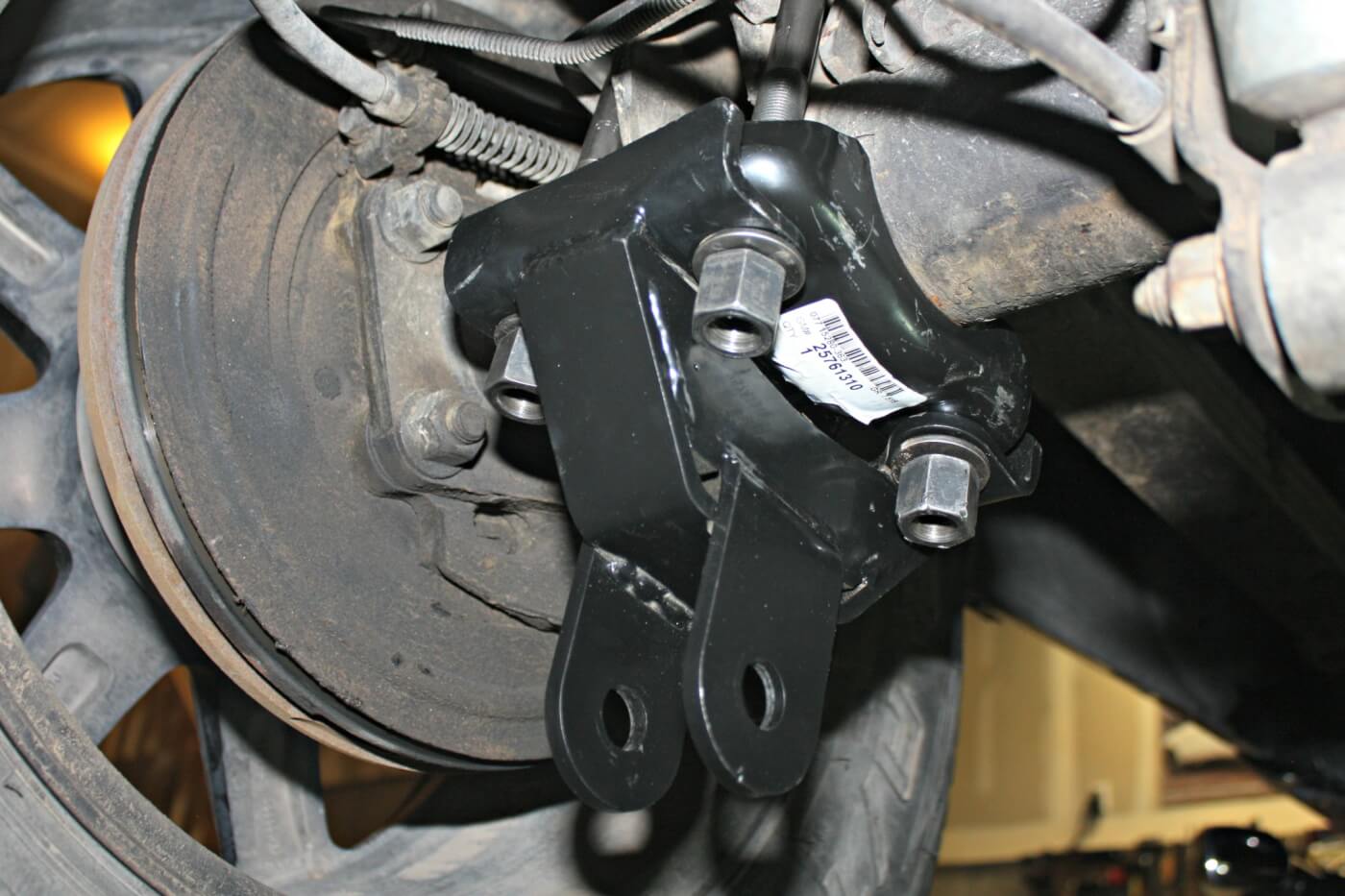 4. Notice the stock lower axle U-bolt clamp plate is retained; the professional grade traction bar bracket is just slid onto the axle U-bolts and the stock washers and nuts are reinstalled. The nuts will need to be torqued to 118ft-lbs. Try to tighten these evenly, so all four have the same length of stud showing when tightened. 