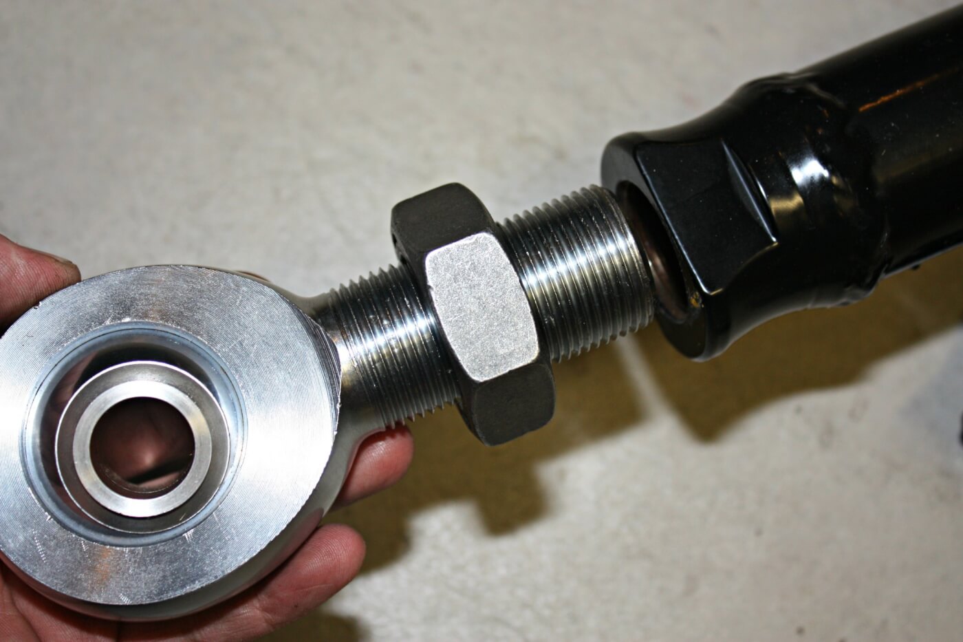 8. After determining which rod end needed to be threaded into each end of the bars, the jam nuts can be spun clear to the rod end, and then the rod end can be inserted into the bars, leaving about a quarter inch of threads sticking out. Remember to allow room for future length adjustment once its installed on the truck.