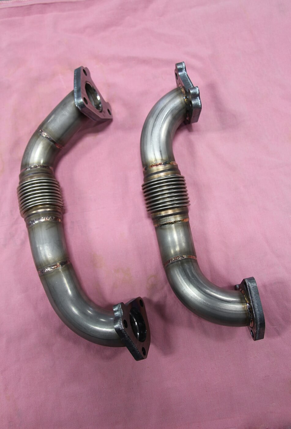 7. Prior to reinstalling the transmission, the guys at Randall’s bolted these high flow up-pipes to the factory exhaust manifolds. Made by Wehrli Custom Fabrication, the symmetrical pipes measure 2-inches in diameter, feature smooth bends, and are made from 11-gauge stainless steel. The primary reason for upgrading to the 2-inch up-pipes is due to them having stronger bellows (the OE bellows can blow out) and the fact that they help decrease exhaust gas temps. 