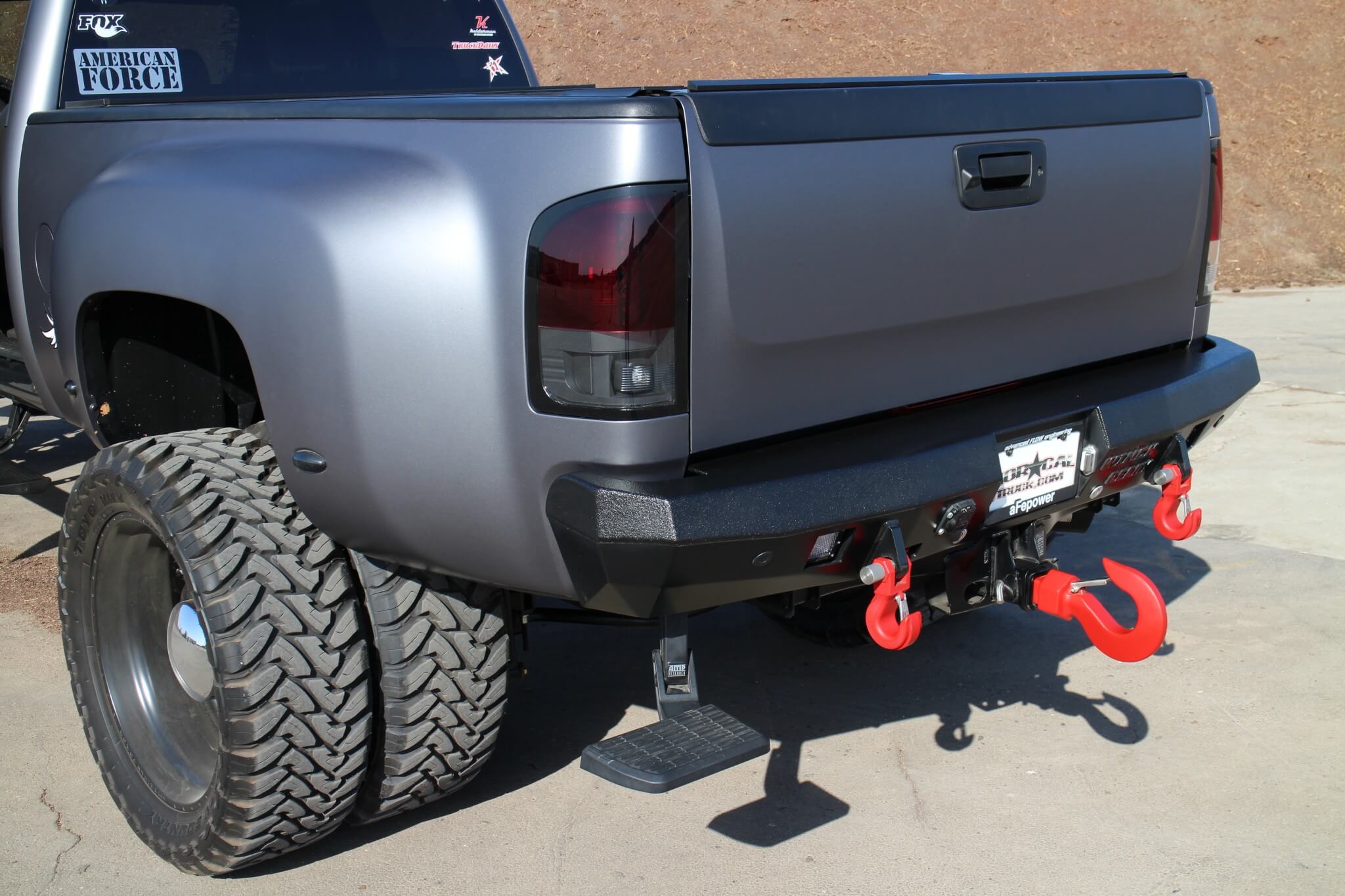 A snug-fitting Winch Ready rear bumper was equipped with a pair of Monster recovery hooks. To gain easier access to the bed, an AMP Research retractable bed step was installed. A larger Monster recovery hook was stuffed and secured into the trailer hitch receiver. 