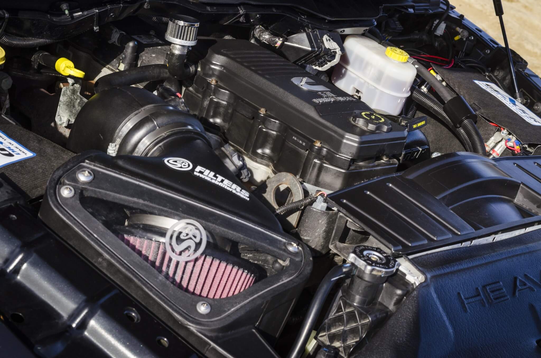 An S&B cold air intake with the scoop kit makes sure only clean air gets into the 6.7L Cummins engine. Jordan uses F-Bomb fuel additive.