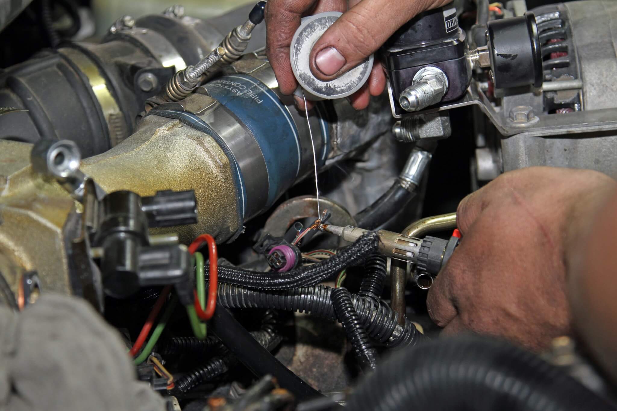 19. Like the rest of the gauge installation, Carter solders and then seals the joints with heat-shrink tubing for a secure connection of the HPOP gauge harness under the hood. A cheap connector could corrode and develop a poor connection over time.