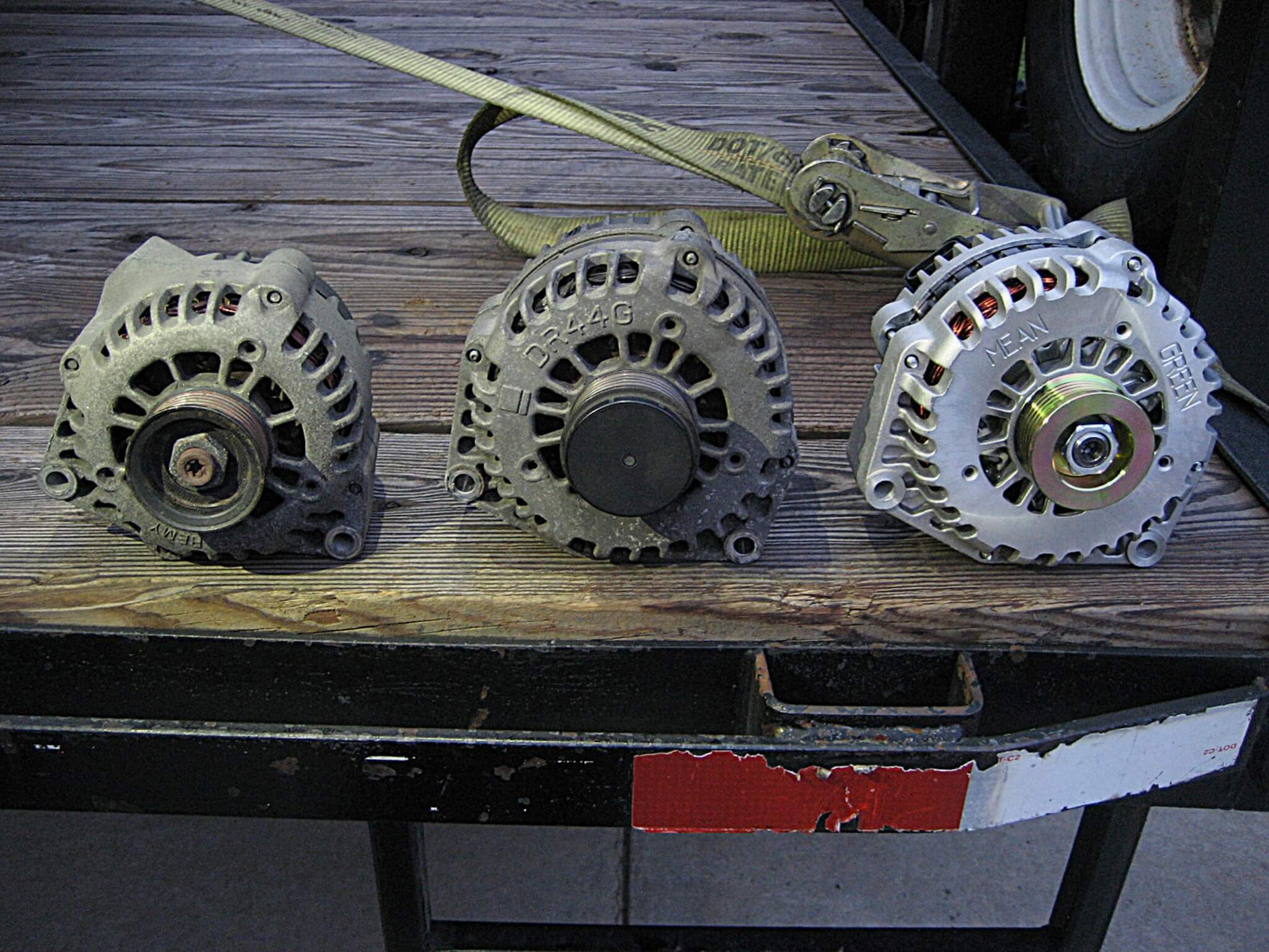1. Here you can see the stock OEM alternator on the left. In the middle is the stock-type upgraded alternator. On the right is the new Mean Green (MG) high-output alternator. The MG unit puts out about two and a half times the amperage of the small OEM unit and 100 amps more than the larger, special order option OEM unit. 