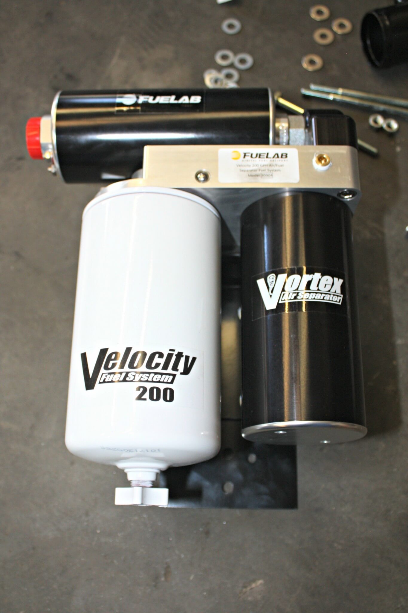 4. Using a rather large fuel filter with a built-in water separation feature, the Velocity system mounts to the supplied bracket. This was mounted inside the driver-side frame rail. The long cylindrical shape to the right of the filter is Fuelab’s unique Vortex air separation chamber that helps to remove any entrapped air from the fuel before it enters the pump that feeds it onto your CP3 and high-pressure injection system. By removing air from the system and better filtering the fuel, you can expect longer life from your injection pump and injectors, as well as reduced engine noise.