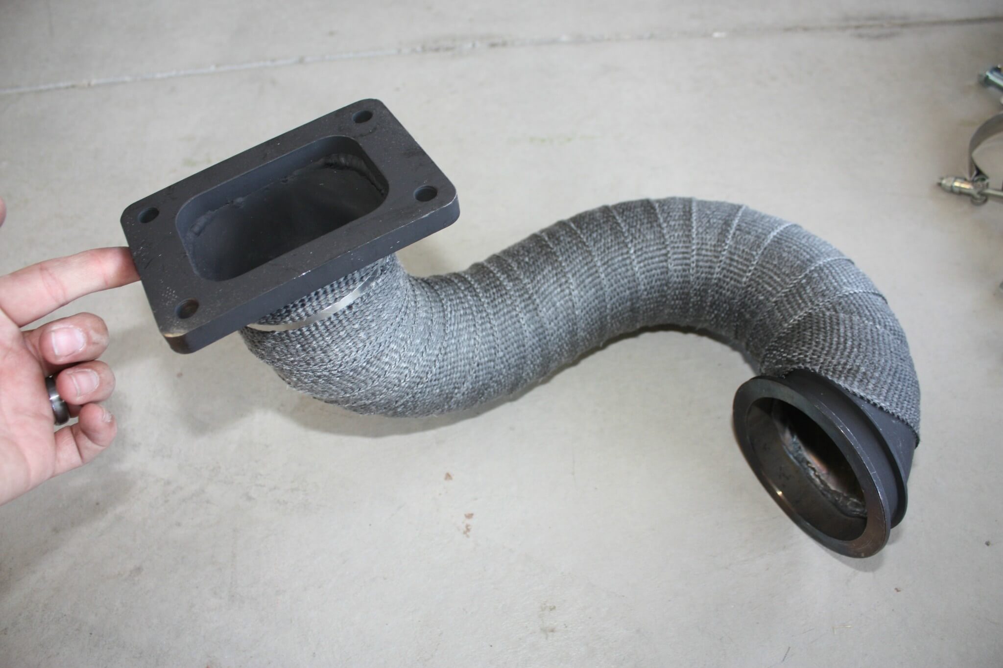 2. The intermediate pipe supplied in the DRP Compound system clamps directly onto the stock turbo, and routes exhaust gases through a tight mandrel-bent 180 to the new S475’s turbine inlet flange. It comes pre-wrapped with header wrap, which serves two purposes: keeping nearby components safe from heat and retaining the exhaust gas heat inside the pipe to drive that big turbine harder.