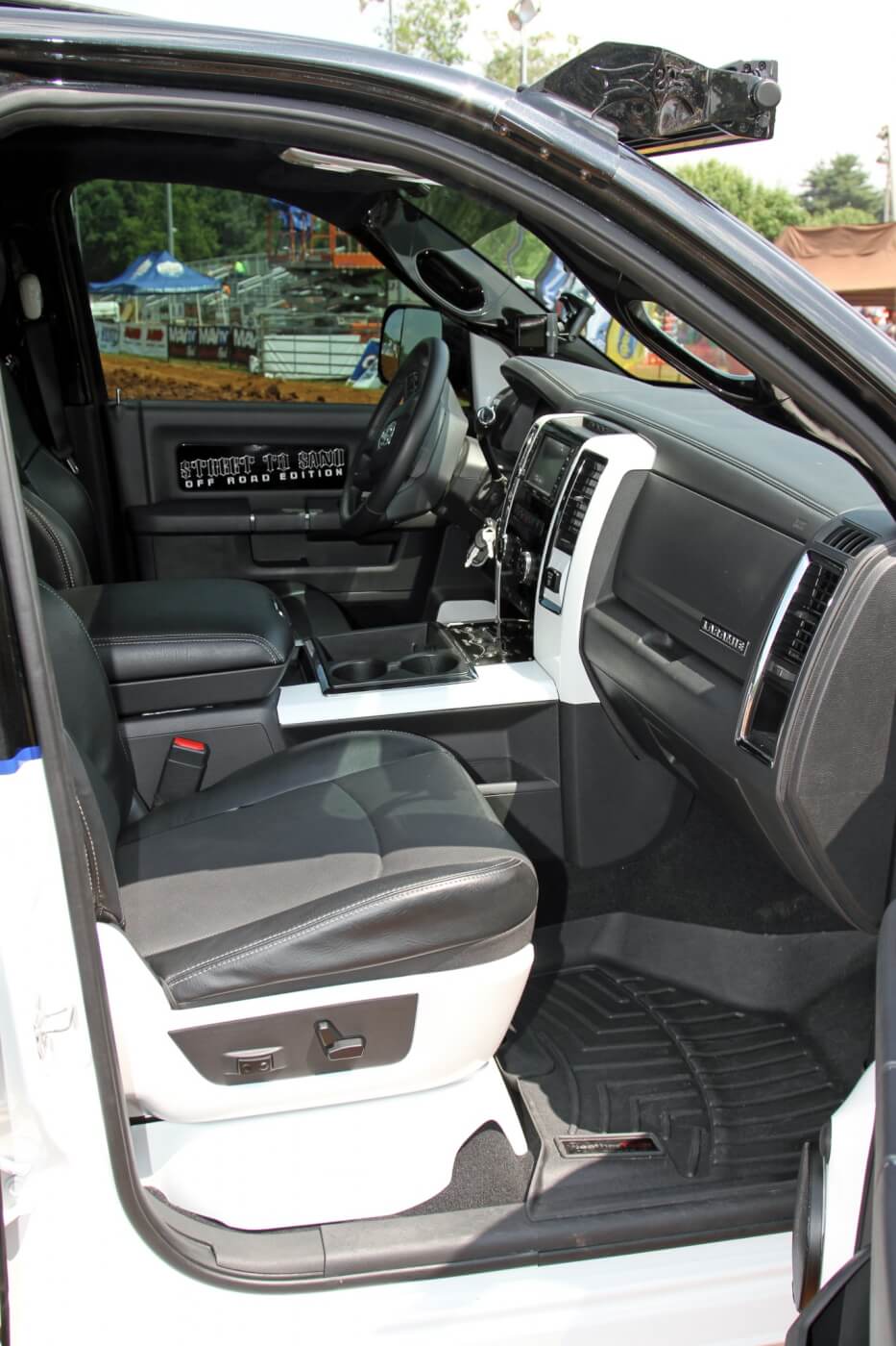 All of the truck’s plastic interior parts were treated to a coating of metallic black or bright white paint to match the exterior. The seats were reupholstered in black leather with perforated inserts embroidered with the S2S logo.