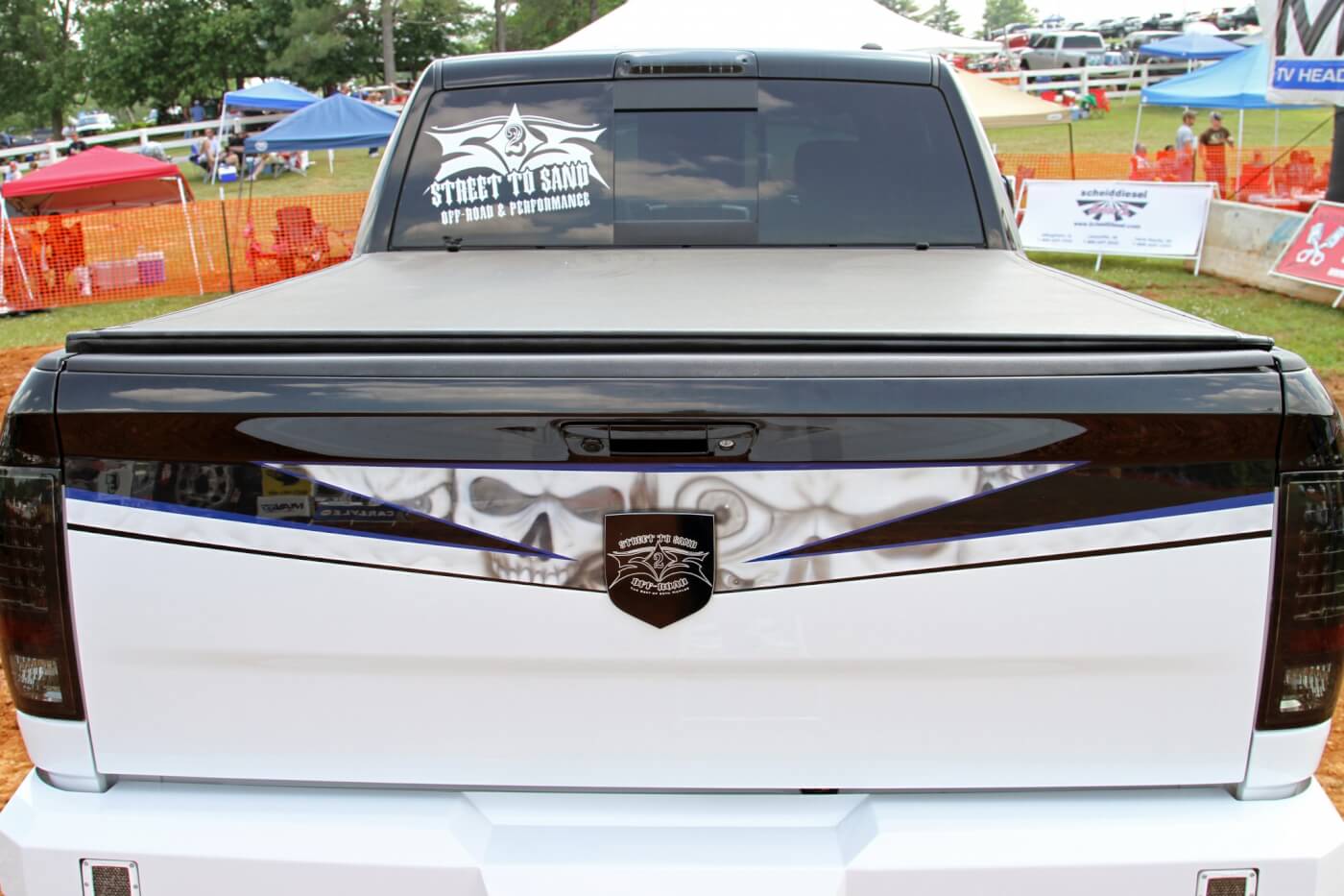An Extang soft tonneau cover keeps marketing swag and product displays protected from the elements while the truck travels from event to event. Recon smoked LED taillights and third brake light flow well with the custom graphics and theme of the truck.